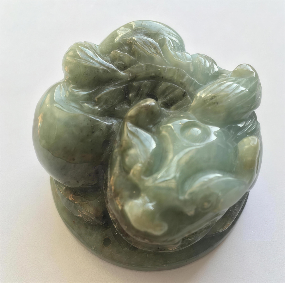 Hand-carved natural jade Chi Lin statue standing majestically on display base